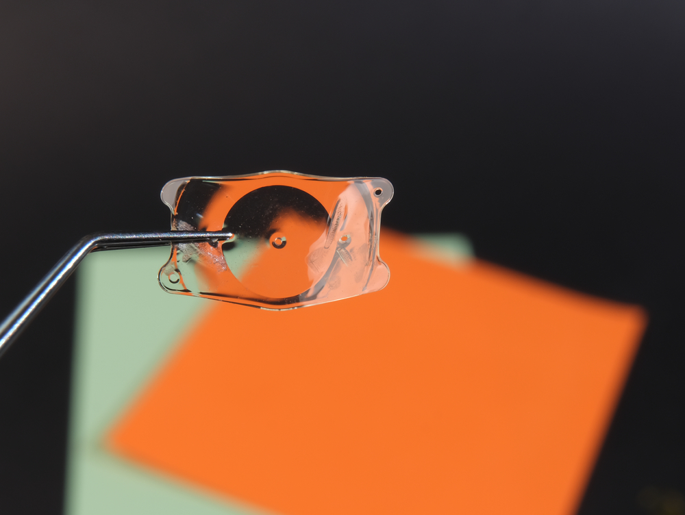 Pair of tweezers holding an implantable contact lens